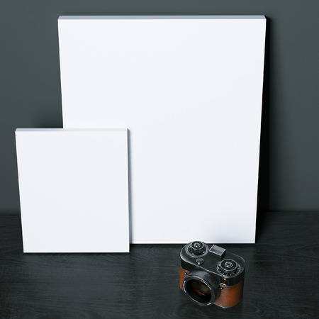 Mock-up blank posters on black surface with vintage photo camera. 3d renderの写真素材