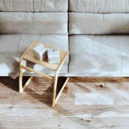 White Scandinavian interior with cozy sofa and wooden minimalistic coffee table 3d renderの写真素材
