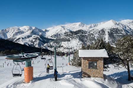 Skiing and snowboarding on the snowy slopes of prepared ski resort in Andorraのeditorial素材