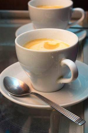 A cup of black coffee with foam
