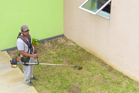 VARADERO, CUBA - JANUARY 05, 2018: A man shearing grassのeditorial素材