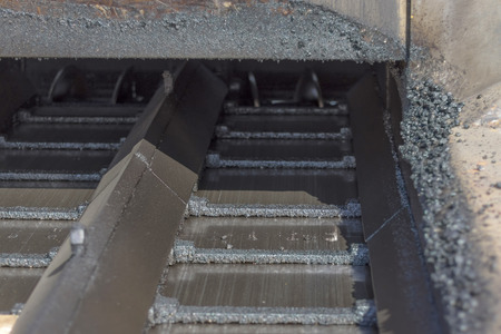 Restoration of paving and laying of new asphalt with special equipmentの写真素材