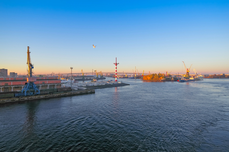 Sea cargo port, view of the water area and moorings with cranes, Sunrise early in the morningの写真素材
