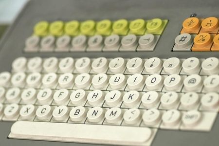 Old dirty computer keyboard with round buttons, closeup fragment