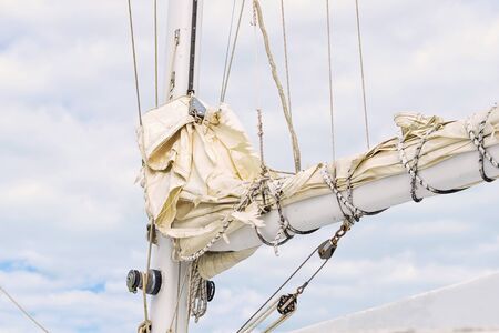 Fragment of snap of a separate mast or spar, on
cloudy sky background. Used to mount the mast and control the sailsの写真素材