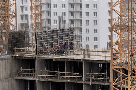 Workers around concrete slabs. Construction of residential home