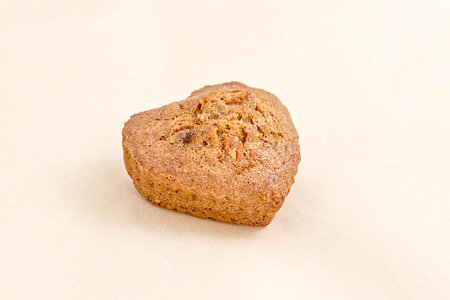 Fresh pastries, brown cake in the shape of a heart. The assortment of bakery and bakery. Closeup on...