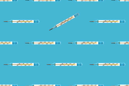 Seamless pattern of medical glass mercury thermometers on a blue backgroundの写真素材