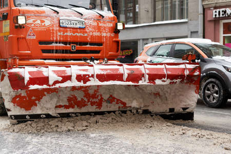 Snowblowers clear the road on the city streetのeditorial素材