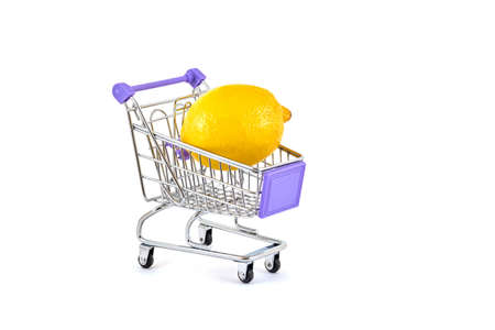 Yellow lemon in a supermarket trolley on a white backgroundの写真素材