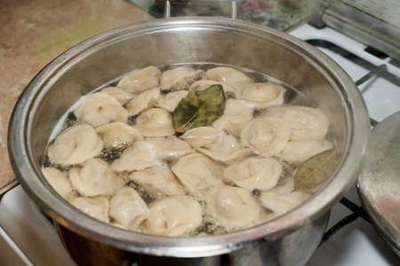Casserole with boiling dumplings in boiling waterの写真素材