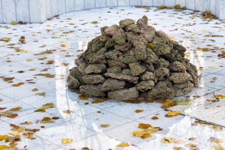 a pile of gray stones lies on light marbleの写真素材