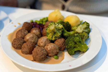 Light blur in the photo of a plate of food, meatballs with broccoli garnish