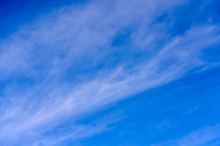 background of clouds of feather clouds on a blue sky.
