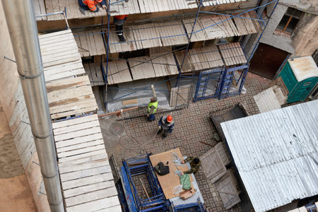 Saint Petersburg, Russia - April 24, 2021: Workers erect scaffolding to repair the facade of a...