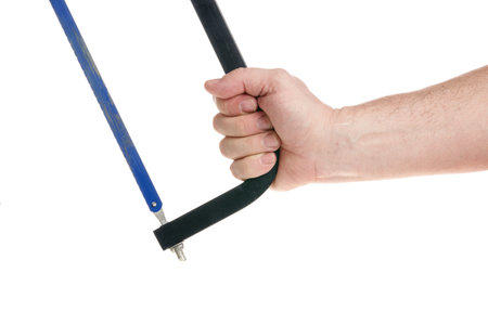 Hand holds a hacksaw on a white background, a template for designers. Close upの写真素材