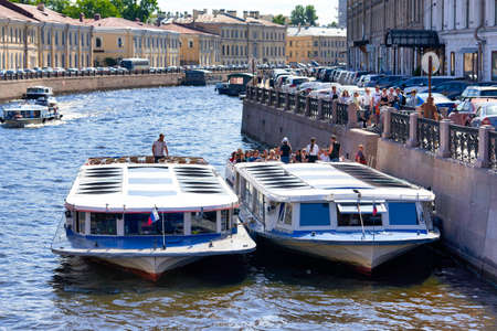 Saint Petersburg, Russia - June 10, 2021: An excursion boat carries tourists along the Neva River in St. Petersburgのeditorial素材