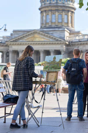 Saint Petersburg, Russia - February 10, 2021: An unknown artist paints the Kazan Cathedral on a street in St. Petersburgのeditorial素材
