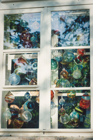 Multicolored glass balls in the window of a glass blowing workshop. Close upの写真素材