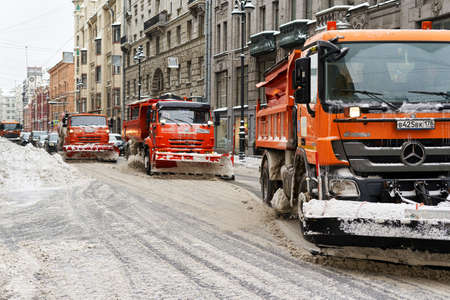 Snowblowers clear the road on the city streetのeditorial素材
