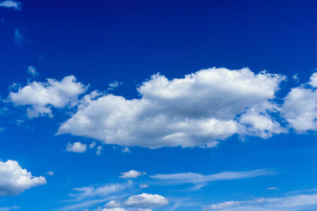 White cumulus clouds on blue sky background, natural phenomenon