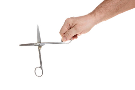 Hand holds medical scissors on a white background, template for designers.