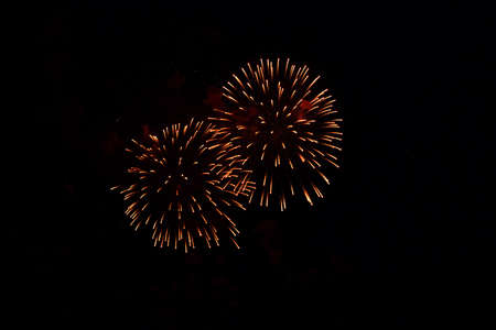 Blurred multicolored fireworks lights against the dark night sky. Festive fireworks. Light defocusの写真素材