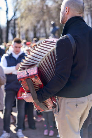 Saint Petersburg, Russia - May 09, 2021: Street musician plays accordion in front of city residents in Saint Petersburgのeditorial素材