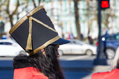 Old hussar hat on the head of a girl with black hair. Close upの写真素材