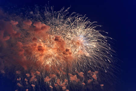 Blurred multicolored fireworks lights against the dark night skyの写真素材
