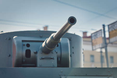 A fragment of an armored vehicle against background of a blurred bus stop signの写真素材