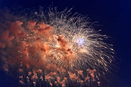 Blurred multicolored fireworks lights against the dark night skyの写真素材
