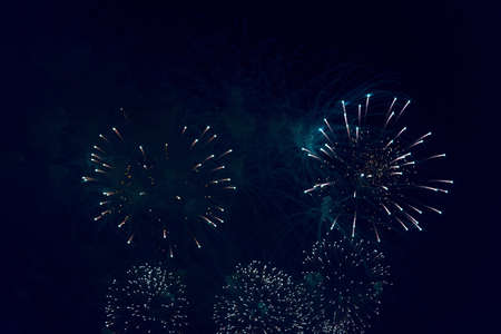 Blurred multicolored fireworks lights against the dark night skyの写真素材