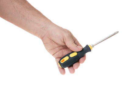 Hand holds a screwdriver on a white background, a template for designers.の写真素材