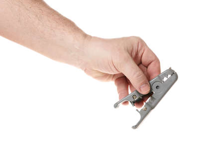 Hand holds a wire stripper on a white backgroundの写真素材