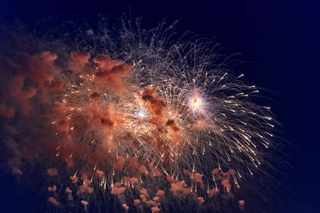 Blurred multicolored fireworks lights against the dark night skyの写真素材