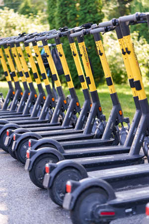 Saint Petersburg, Russia - August 08, 2021: Rental electric scooters in a shared parking lot in the city park in Petersburgのeditorial素材