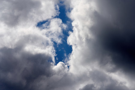Cloudy clouds before a thunderstorm with a skylight to the blue skyの写真素材