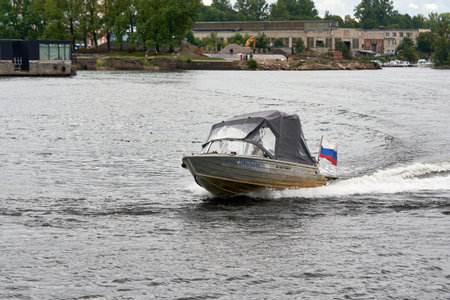 Saint Petersburg, Russia - August 09, 2021: A small boat quickly floats on the Neva River