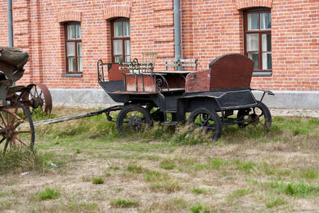 Old carriage in a rural courtyard on a summer day. Vintage carriageの写真素材