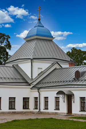 Fragment of the bell tower of a Christian church with a blue roof. Church bell tower against the skyの写真素材
