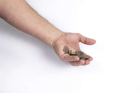 Hand holds a handful of coins on a white background, template for designersの写真素材