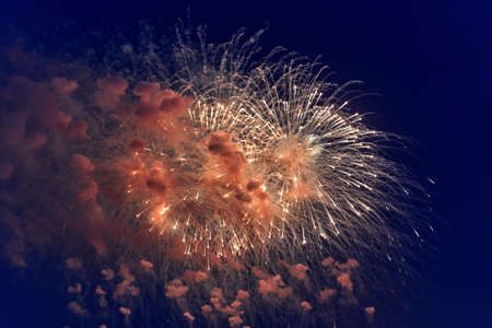 Blurred multicolored fireworks lights against the dark night skyの写真素材