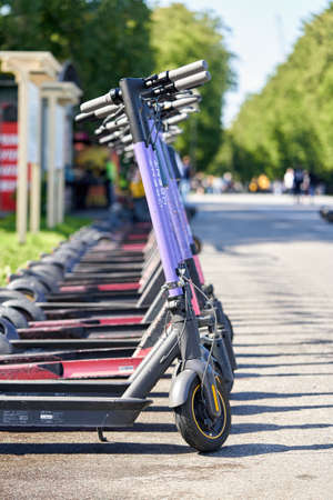 Rental electric scooters in a shared parking lot in the city parkのeditorial素材