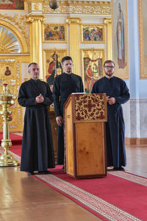 Priests in black robes conduct a service in a Christian churchのeditorial素材