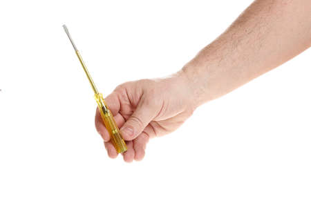 Hand holds a screwdriver on a white background, a template for designers.の写真素材