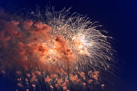 Blurred multicolored fireworks lights against the dark night skyの写真素材