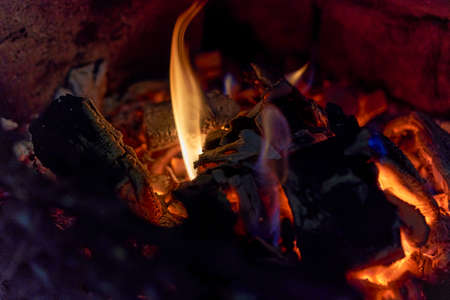 Burning black coals and fire bred in the fireplaceの写真素材