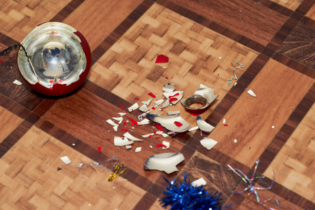 Broken christmas decoration and shards lie on the floor