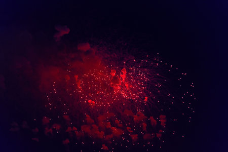 Blurred multicolored fireworks lights against the dark night skyの写真素材